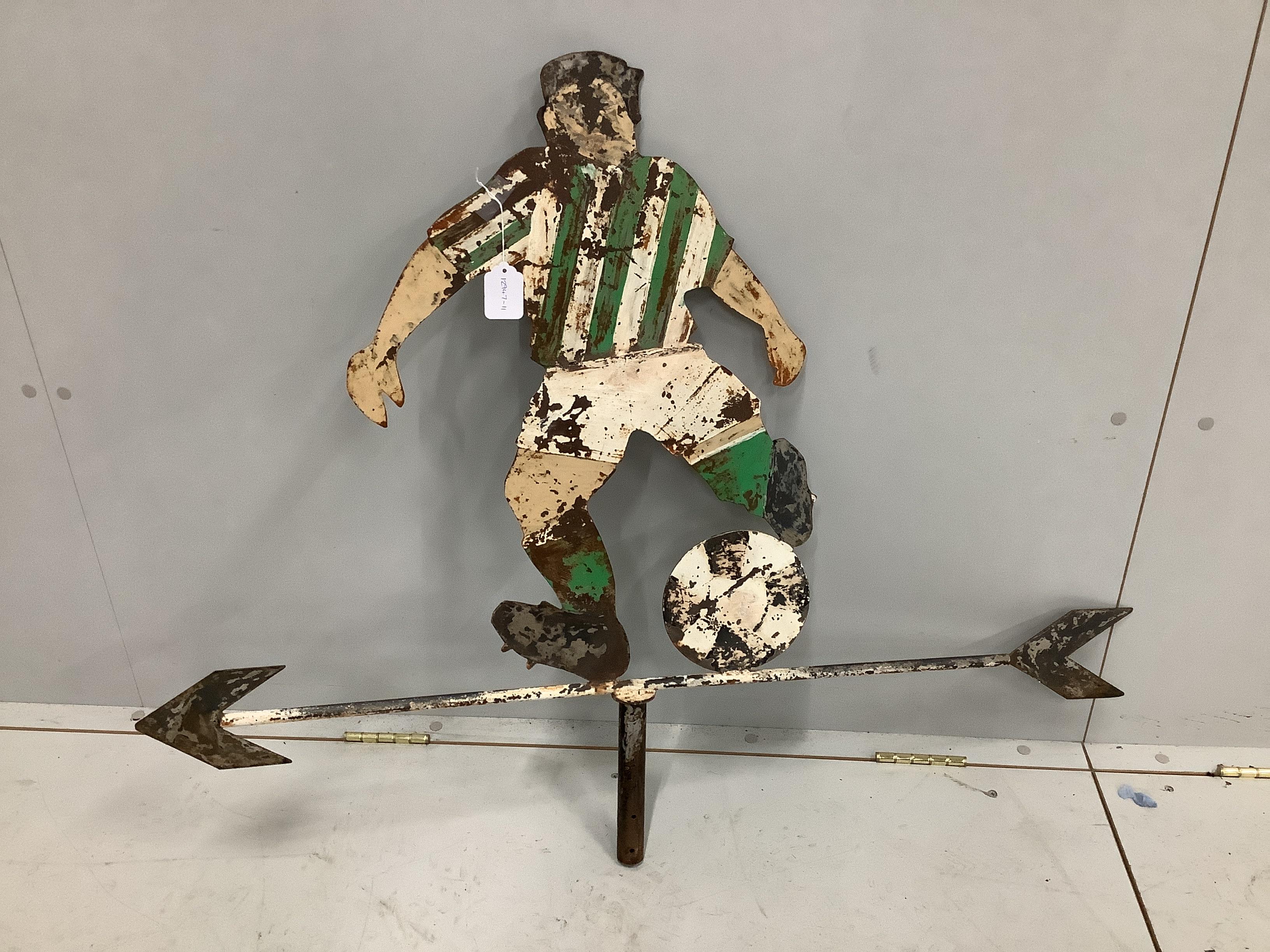 A vintage painted sheet steel weather vane modelled as a footballer, width 109cm, height 85cm